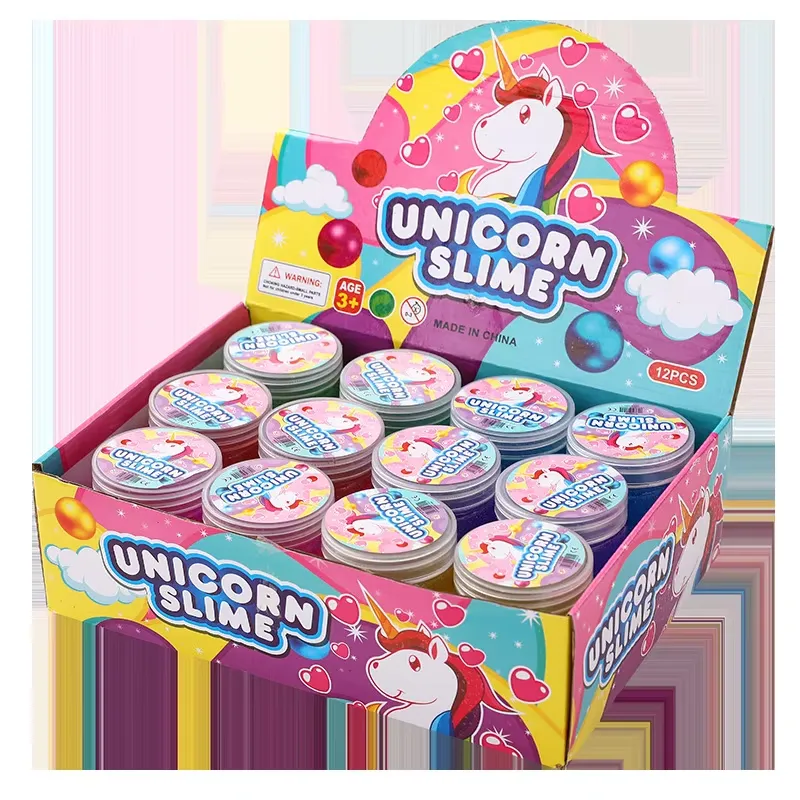 Embalaje del Kit de Slime Transparente para Niños – una caja de exhibición minorista colorida etiquetada como Unicorn Slime que contiene 12 frascos pequeños de slime con clasificación de edad de 3+.